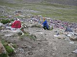 Tibet Kailash 09 Kora 03 Shiva Tsal It took us 85 minutes to trek from Dirapuk to Shiva Tsal (5330m), said to be a replica of the fabled burial ground at Bodh Gaya India. To be reborn one must first die, and here the pilgrims face Yama, the Lord of Death, whose judgment purifies him for the new life awarded atop the D�lma La. It is a rocky expanse dotted with stone cairns draped with items of clothing. Pilgrims are supposed to undergo a symbolic death at this point, leaving their old life behind along with an item of clothing to represent it, a drop of blood or a lock of hair. I left a pair of socks while Pete left a hat.